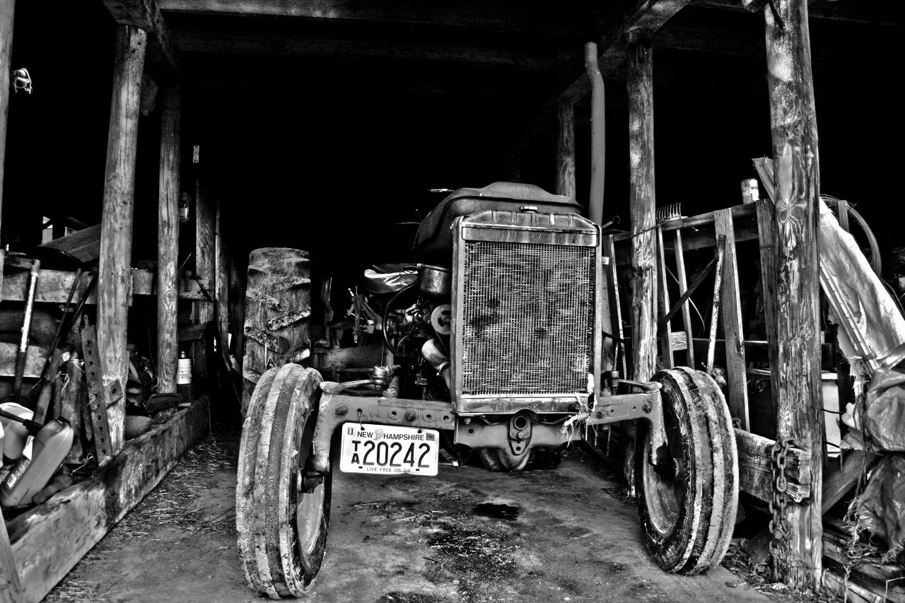 An old tractor in a barn - Photo by Tom Lambert An old tractor in a barn - Photo by Tom Lambert